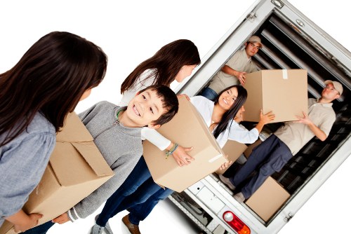 Professional movers handling furniture during a Belsizepark relocation