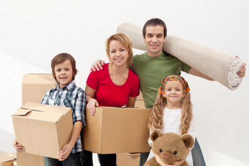 Local removals team handling furniture in a Belsize Park flat