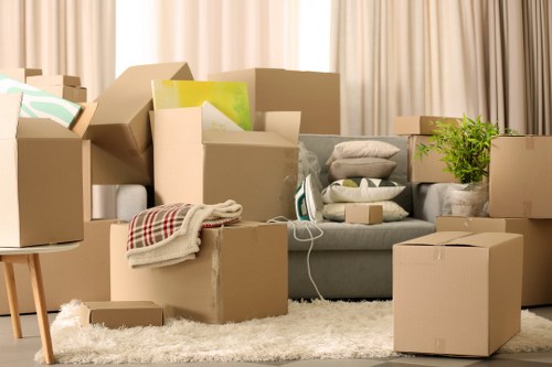 Boxes and furniture being loaded by a man and van in London