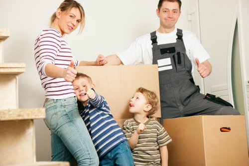 Boxes and furniture being moved from a compact flat on a residential street in Belsize Park